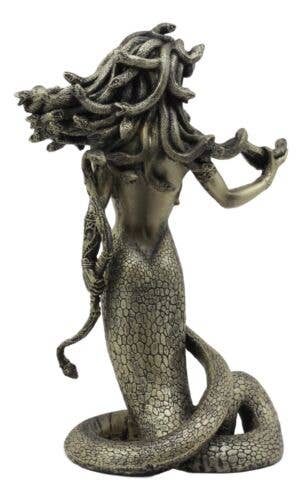 Decorative statue of a woman with snake-like hair and body on a white background