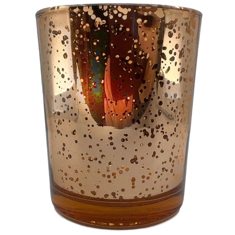 Amber glass votive candle holder with a textured surface.