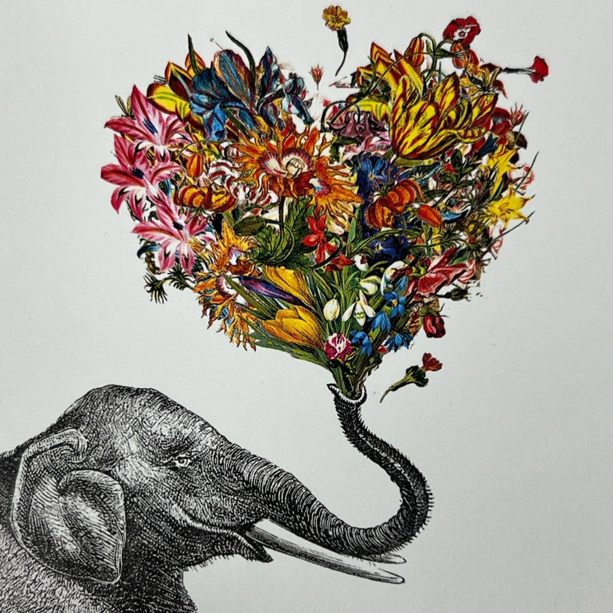 Elephant blowing a heart-shaped bouquet of flowers.