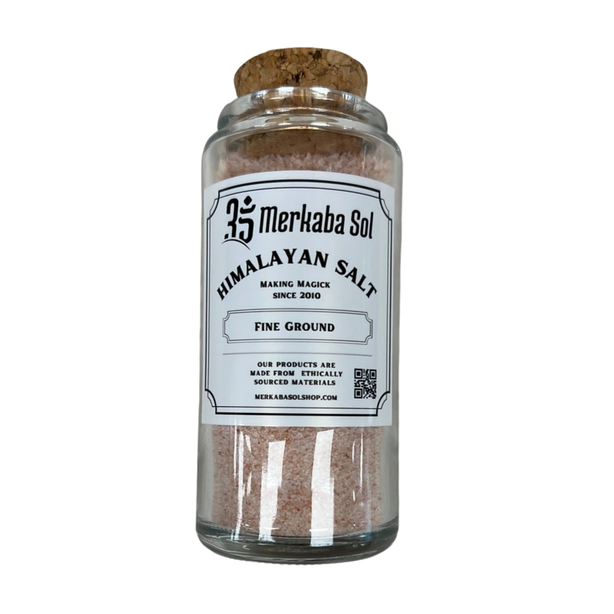 A glass jar with a cork lid filled with fine-ground Himalayan salt. The label reads "Merkabasol Himalayan Salt" and includes additional information about the product.
