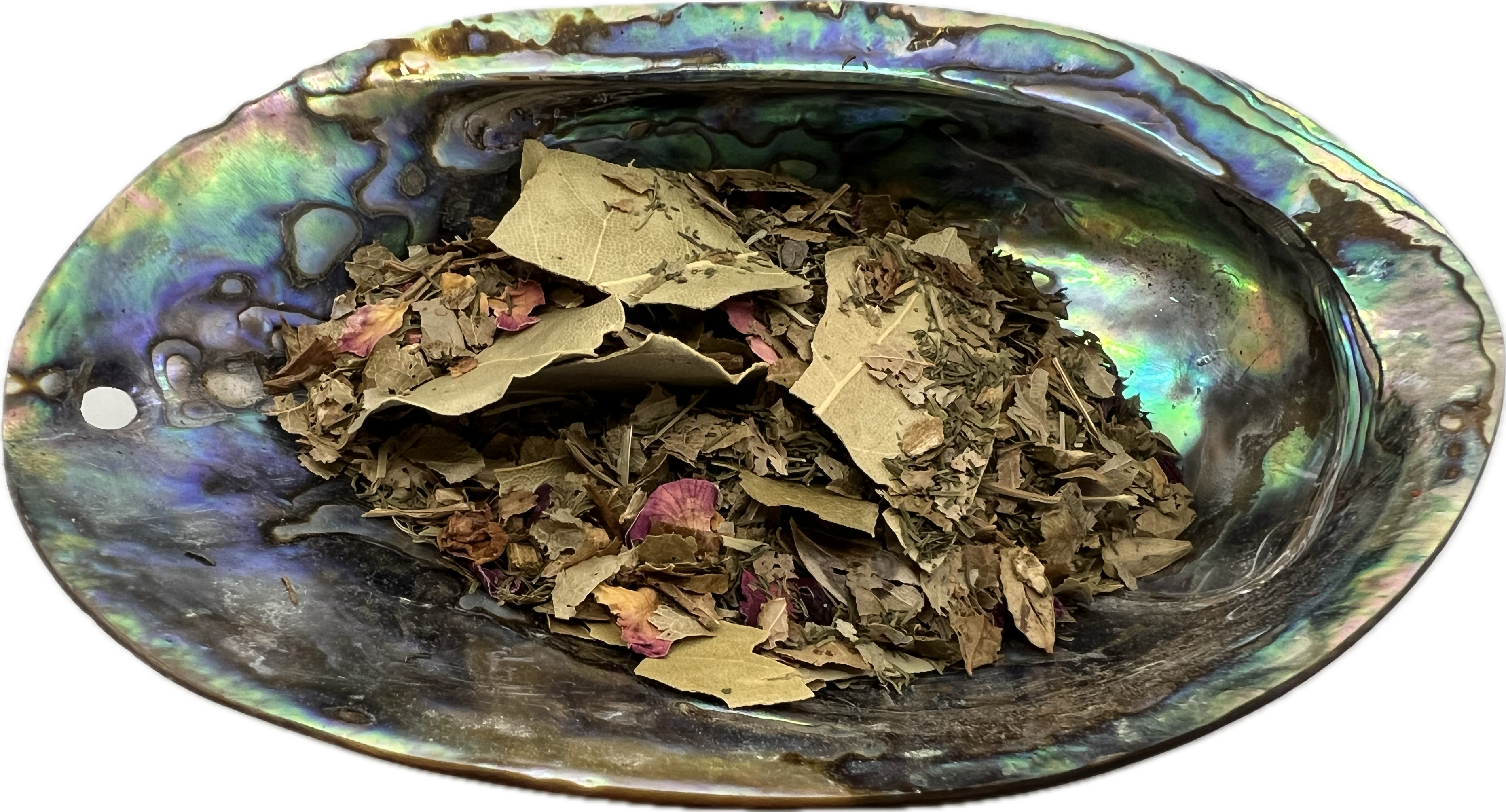 a mix of dried herbs in a shell bowl