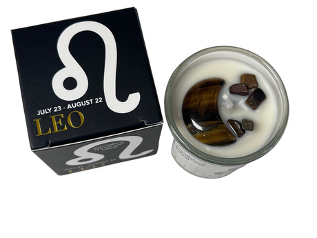 Candle with dark crystals  next to a box with a Leo symbol and dates