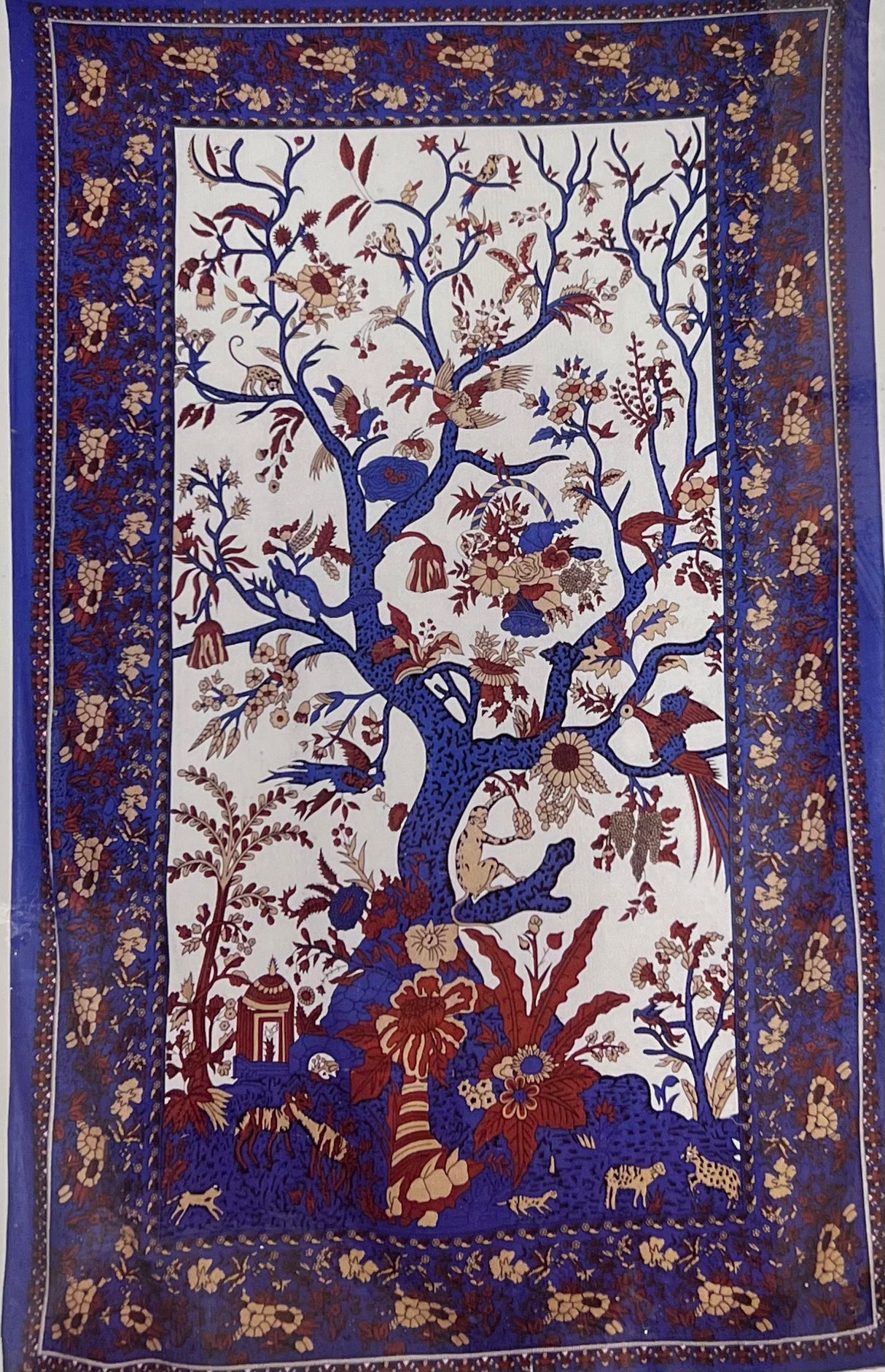 large purple tapestry with image of tree and a bird