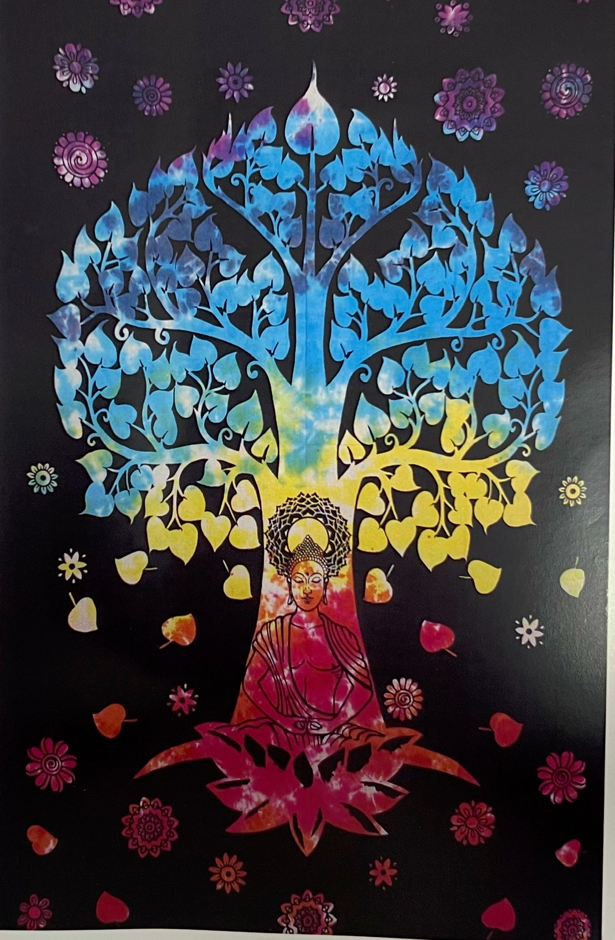 large black tapestry with colorful tree and sitting buddha