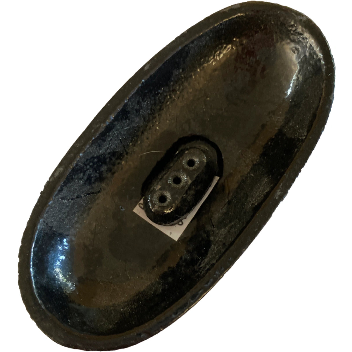 Black oval cast iron incense burner with three small holes.