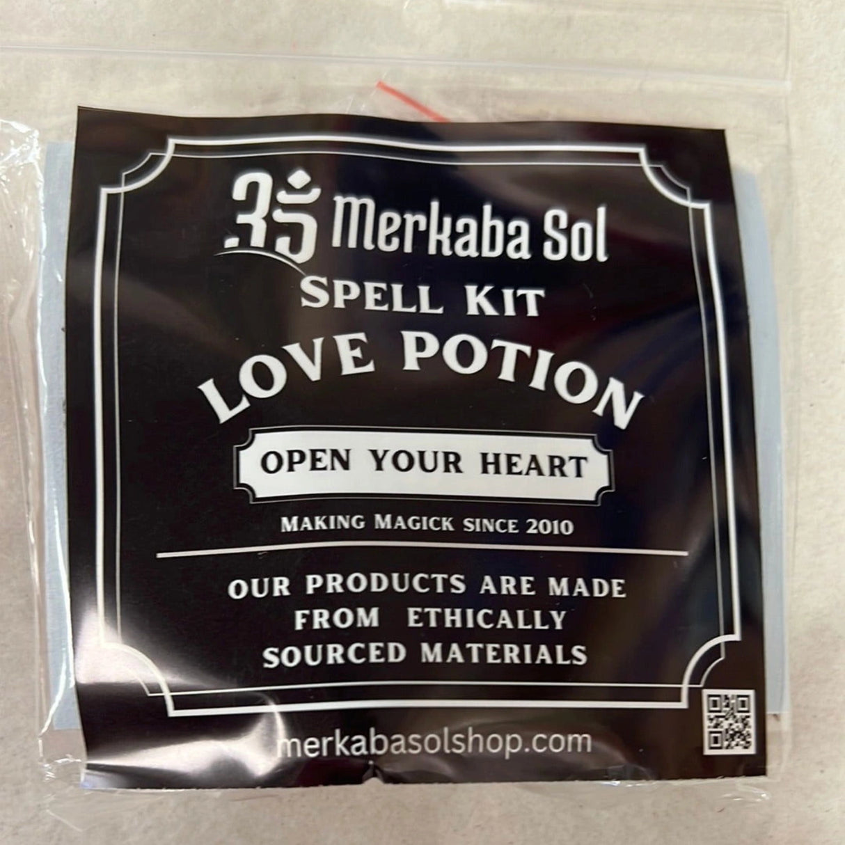 Love Potion Spell Kit with Transparent packaging, Black Label, and white text.