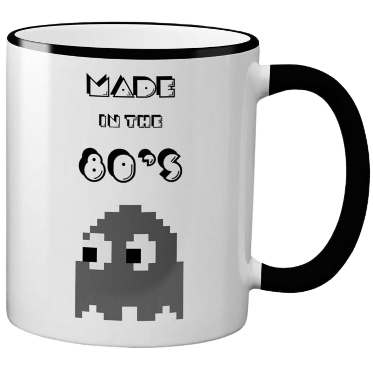 White ceramic mug with black text that reads "MADE IN THE 80'S" and a Pac-Man ghost graphic. The mug has a black rim and handle.