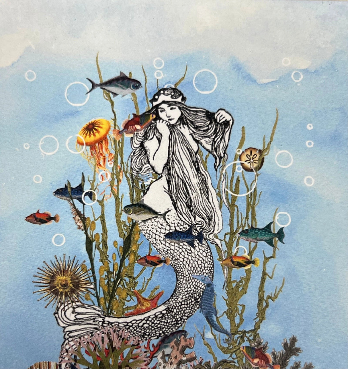 Mermaid Magnet with a mermaid surrounded by colorful fish and sea creatures.