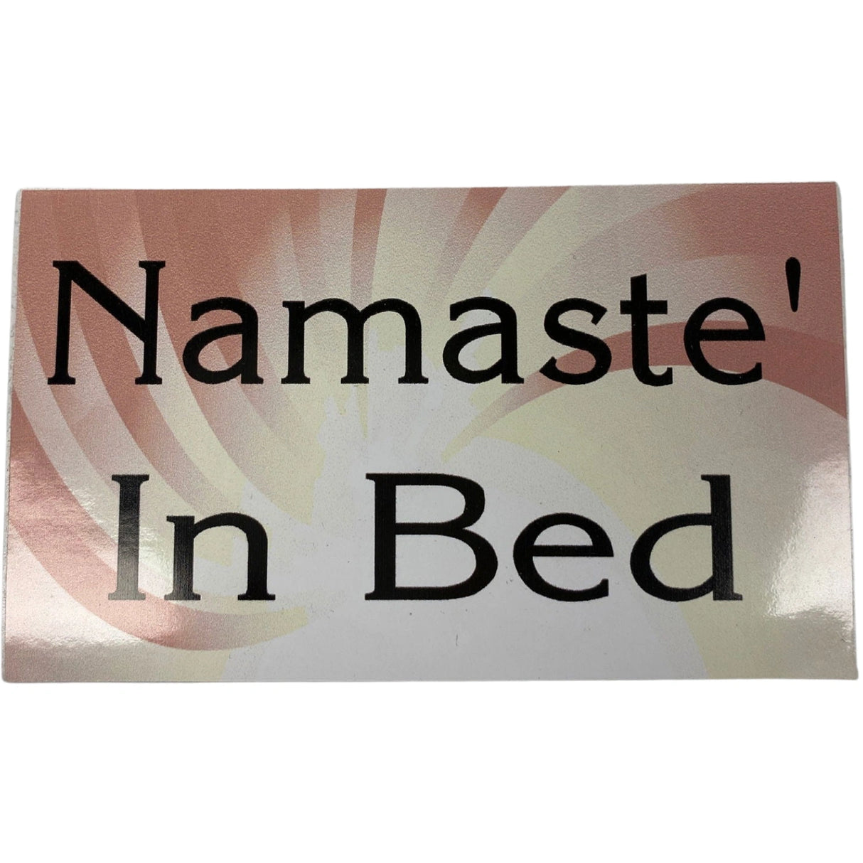 Namaste in Bed sticker, pink background with black text.
