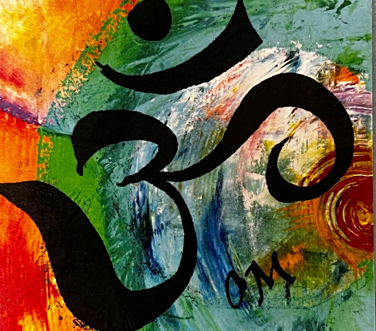 OM Canvas Magnet with the sacred symbol "OM" in black, surrounded by colorful abstract brushstrokes in shades of orange, green, blue, and purple.
