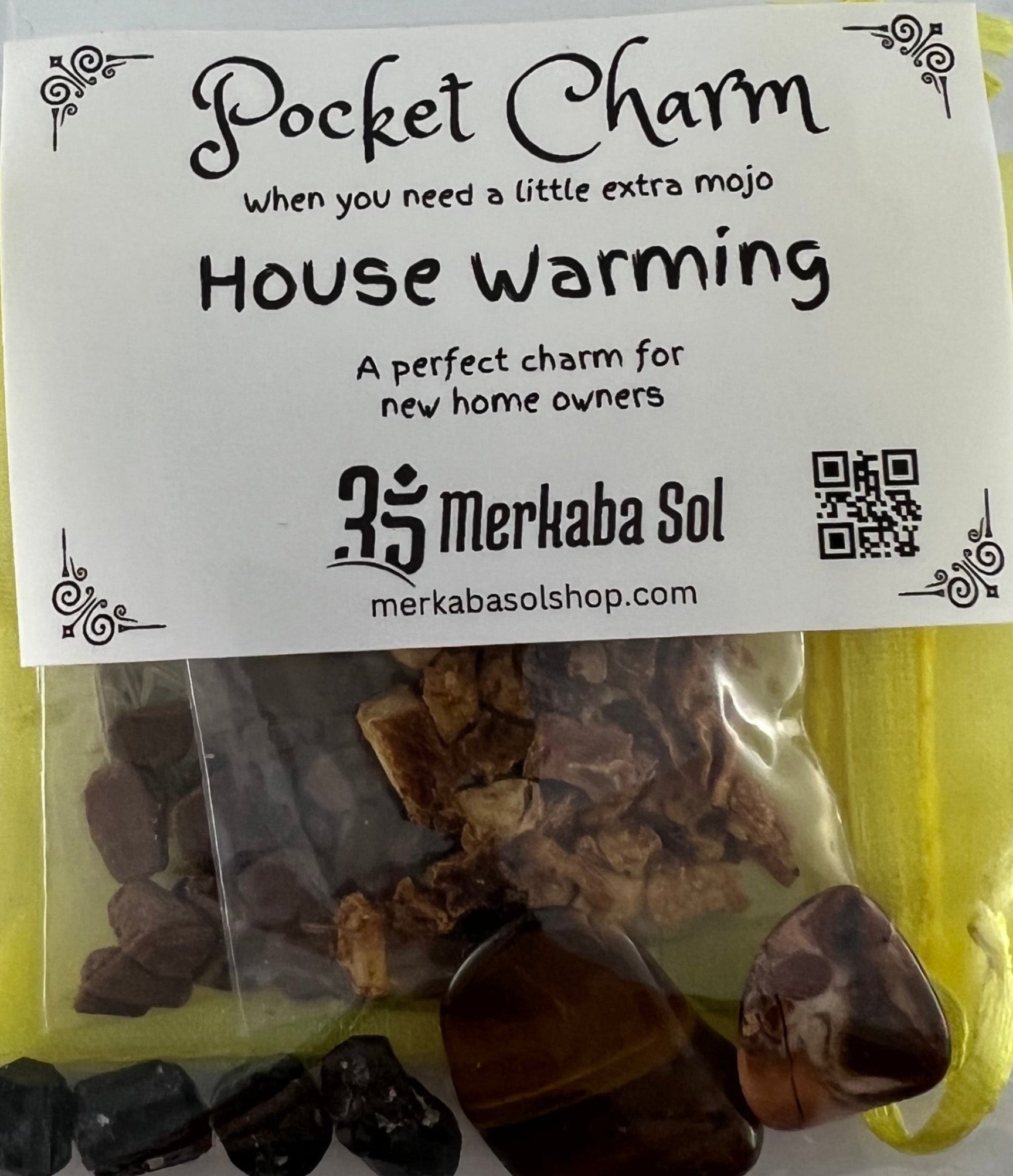 Package is see through with white label  that says Pocket Charm Housewarming 