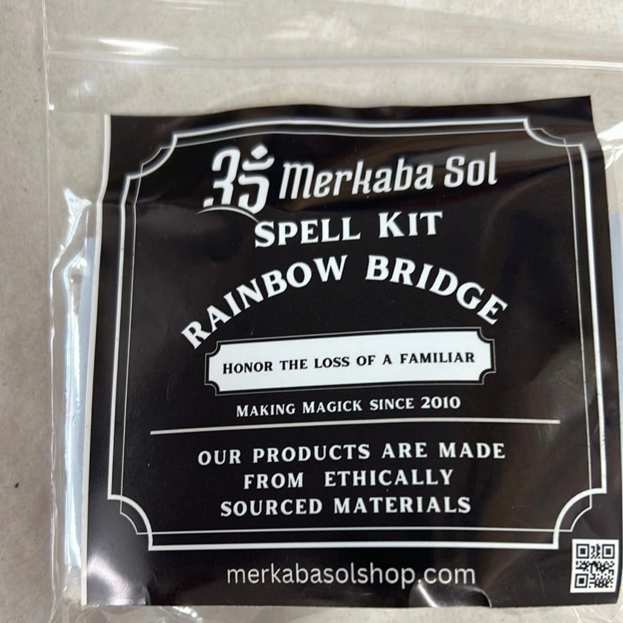 Rainbow Bridge Spell Kit with Transparent packaging, Black Label, and white text.