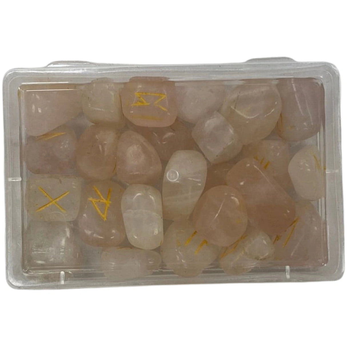 Pink rose quartz stones with gold runes engraved on them in a clear plastic box.