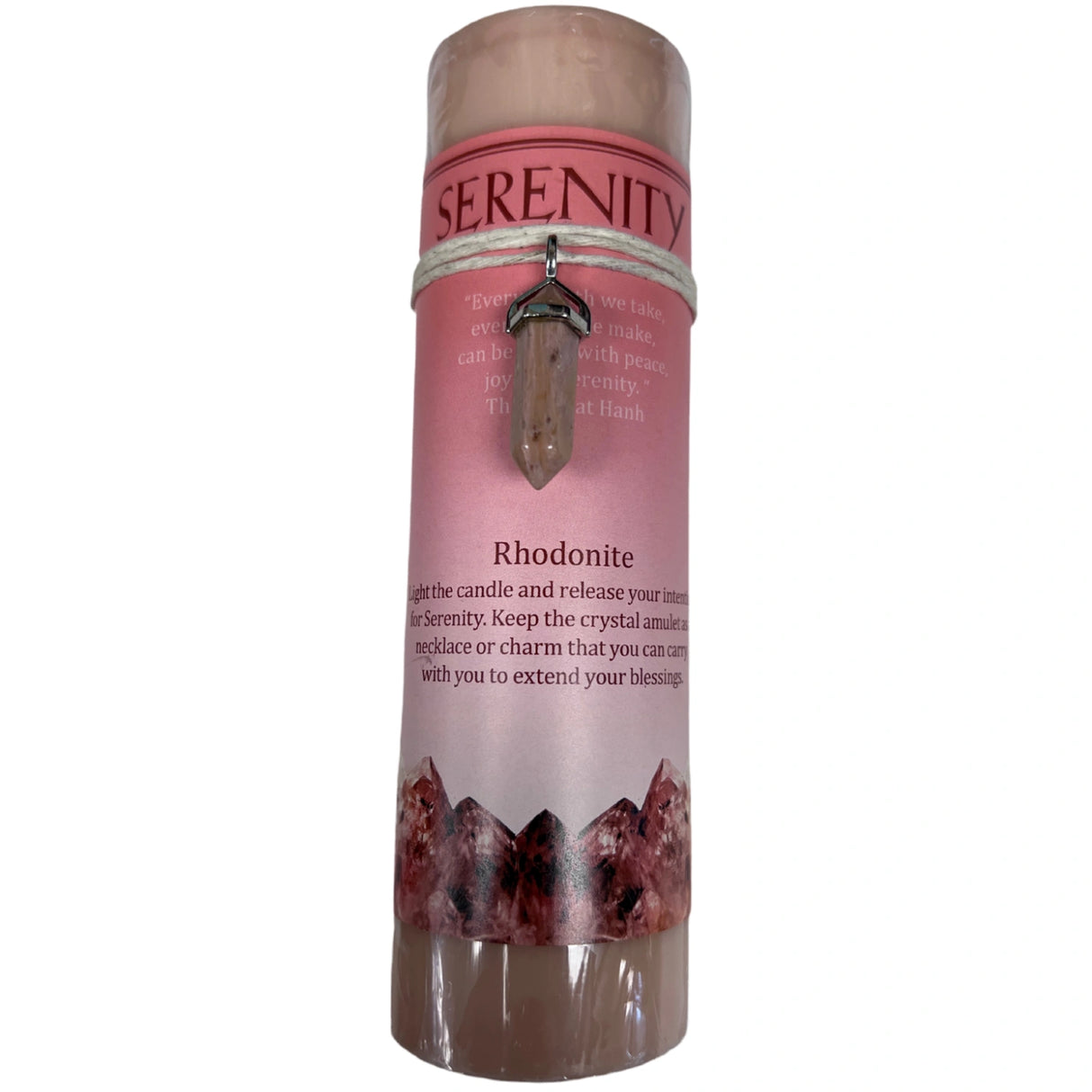 Red candle with "SERENITY" label and crystal pendant.