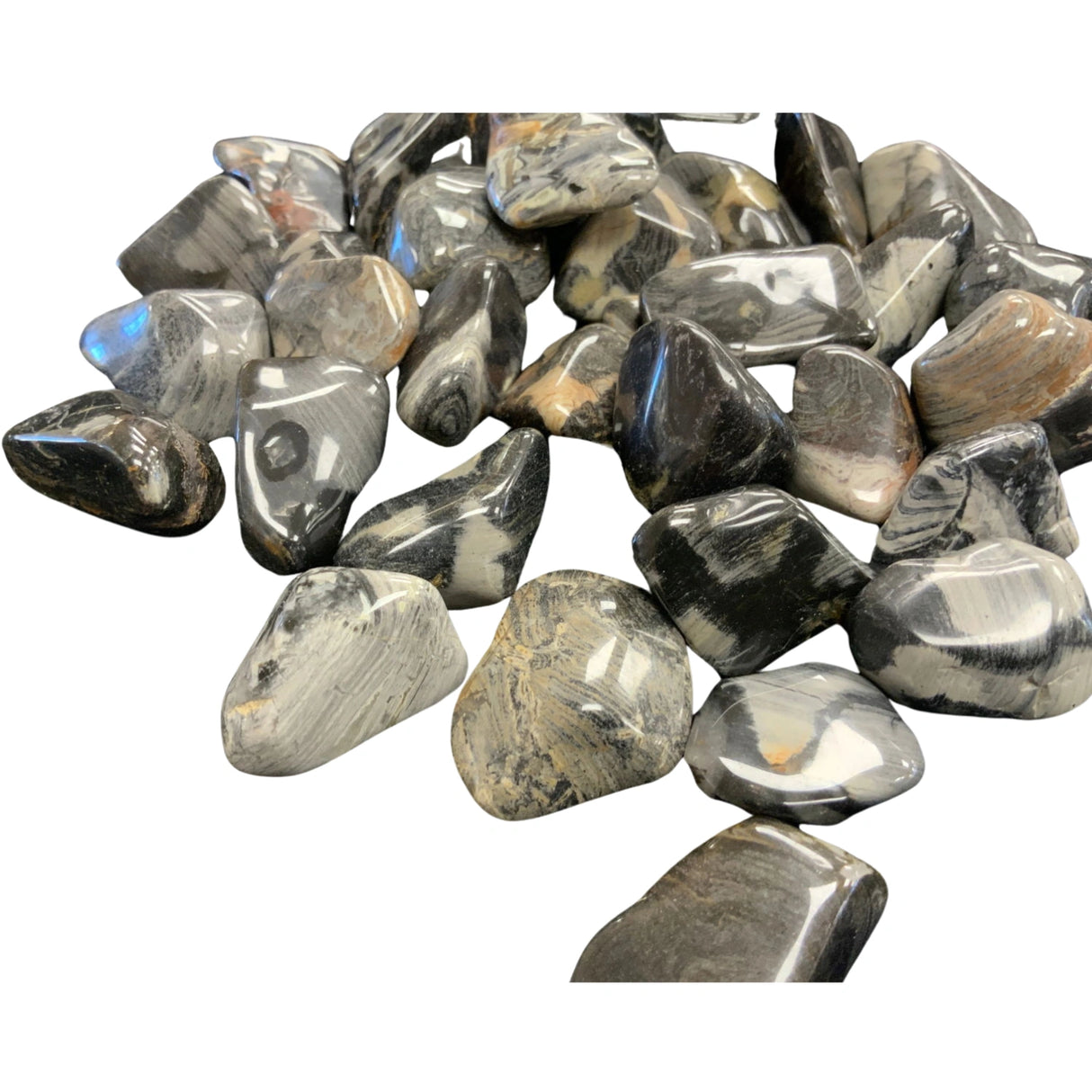 Silver Leaf Jasper Tumbled - Polished stones with black and white patterns.