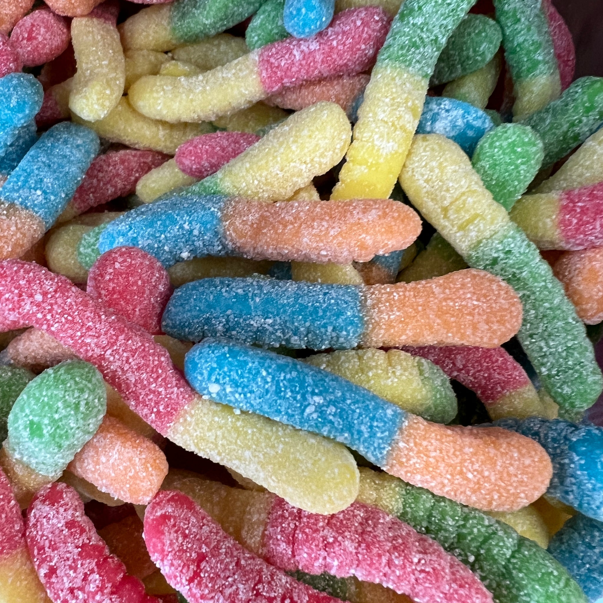 Worm Shaped chewy candy, multiple colors covered in white sugar 