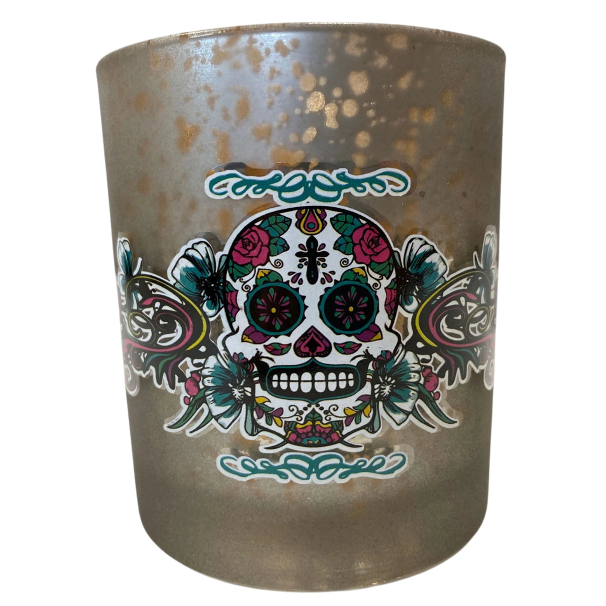 Glass votive candle holder with a silver metallic finish and a Day of the Dead sugar skull design.
