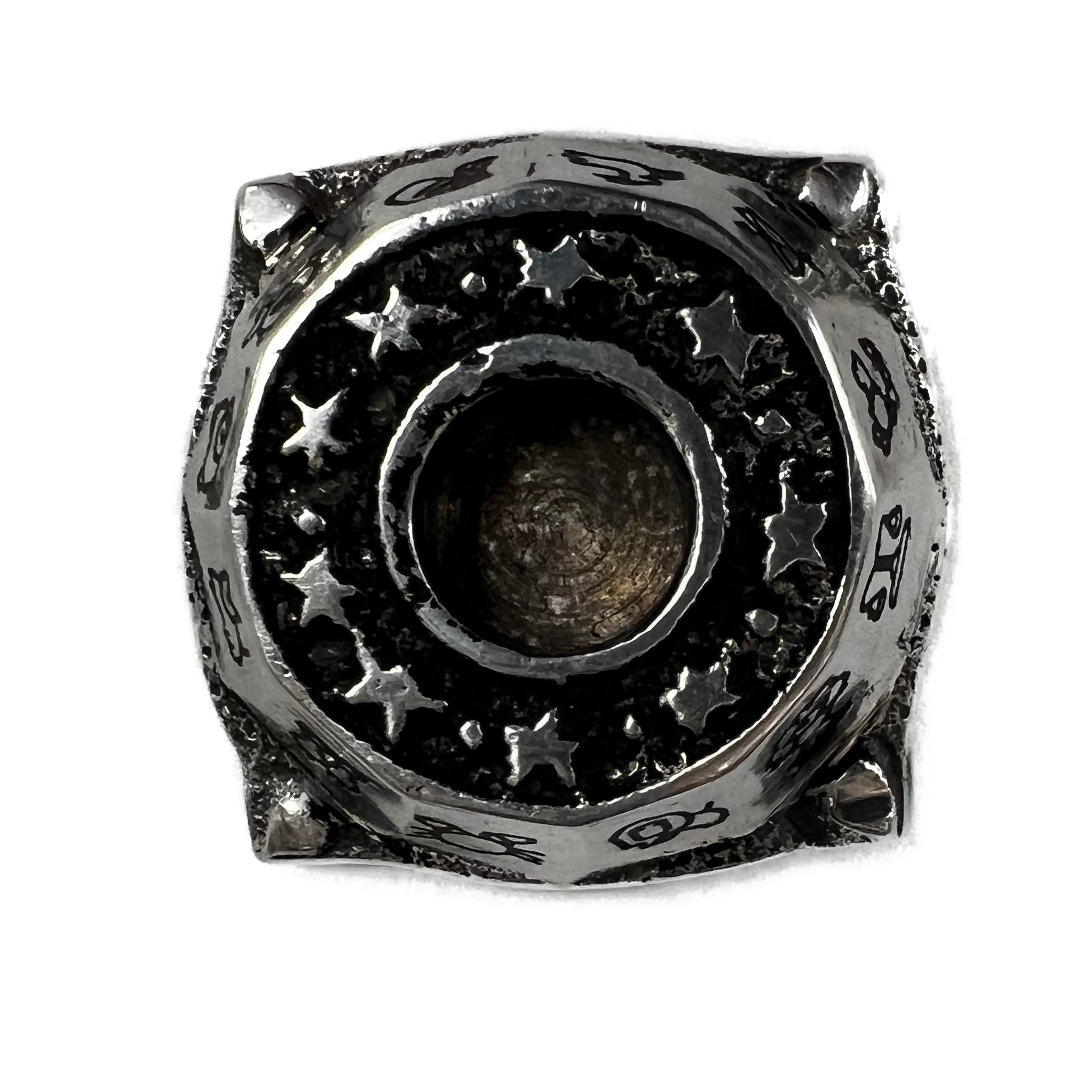 top of candle holder with stars surrounding the hole 
