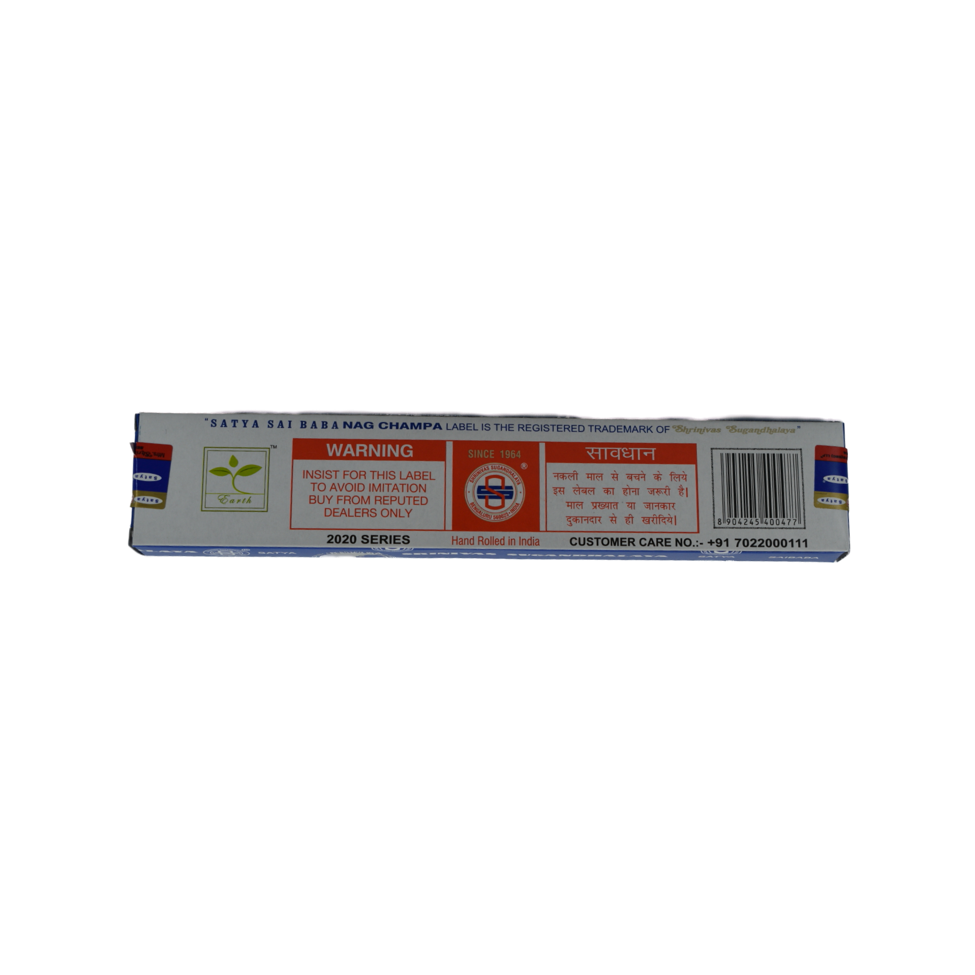 Nag Champa 100gr Incense Sticks back cover.  The bottom of the box is white.  The rectangle in the center is divided into three sections.  The left section has a red banner with white lettering that says Warning.  Below in red letters it say Insist for this label to avoid imitation buy from reputed dealers only.  The center section has a red box with a white circle in the middle with the company trademark logo.  Above the circle  title say Since 1964.  
