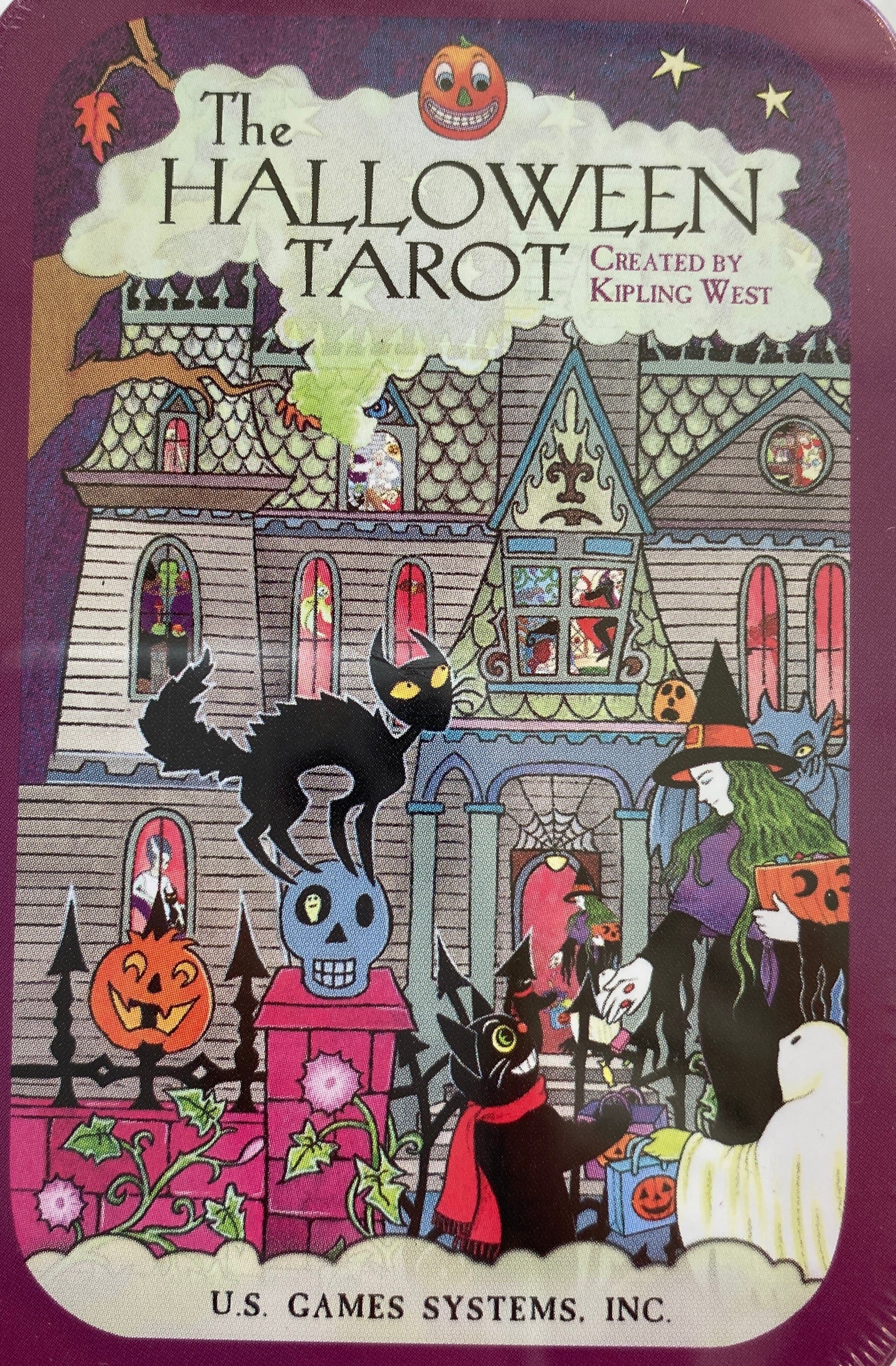 Purple tin box with cartoon haunted house and halloween ghouls 