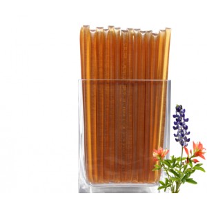 Clover Honey Straw.  A clear, plastic straw heat sealed at each end holding a translucent, tan, clover honey syrup within.  