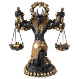 Decorative statue of a figure with a headdress, holding scales, on a white background
