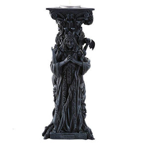 Decorative black pedestal with intricate designs on a white background
