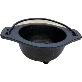 Small black cast iron cauldron with a pentagram design and a metal handle.