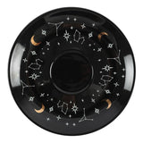 Black plate with star and constellation designs on a white background