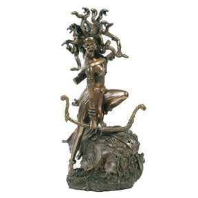Bronze statue of a mythological figure with snakes on a white background