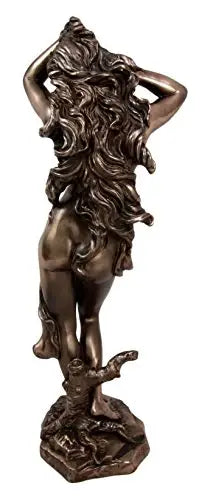 Bronze statue of a woman with lioness features on a white background