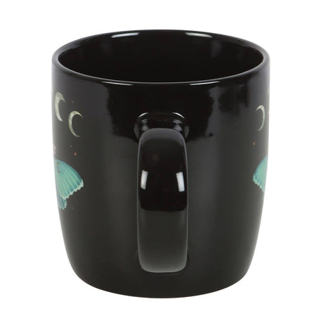 Black mug with mermaid designs on a white background