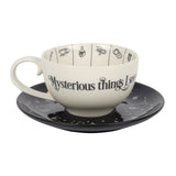 Ceramic cup and saucer set with 'Mysterious things see' text on a white background