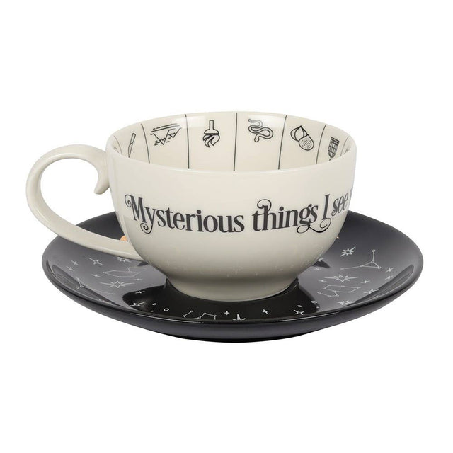 Ceramic cup and saucer set with 'Mysterious things see' text on a white background