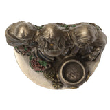 Decorative wall piece with three figures and floral elements on a white background
