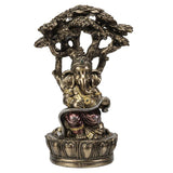 Decorative Ganesha statue seated figure with a tree-like structure on a white background