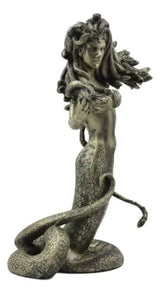 Statue of a woman with a snake on a white background