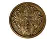 Golden colored disk with a image of the green man in relief 