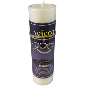 White candle with "WICCA" and "BALANCE" labels.