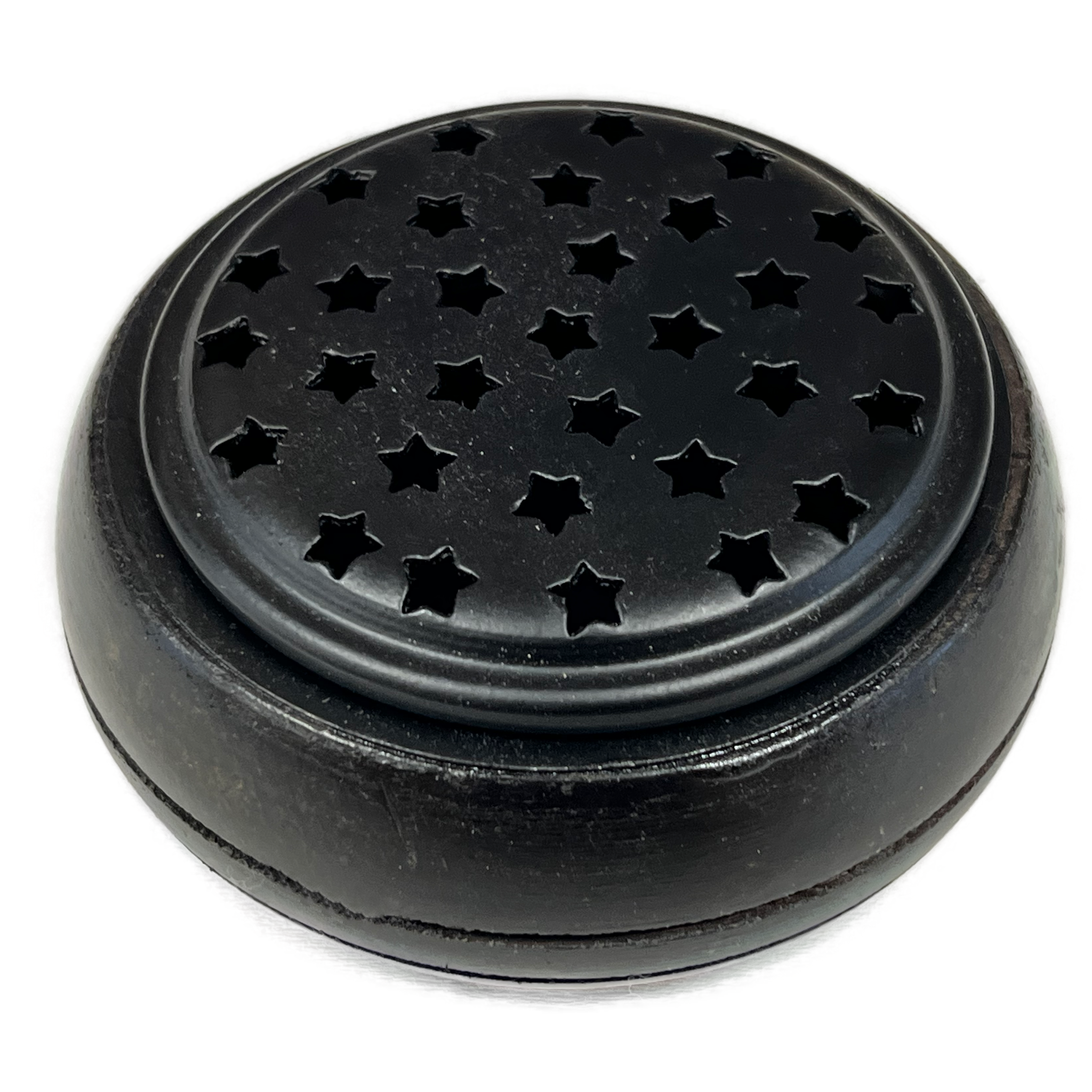 Round metal container with a metal top with little star shape holes 