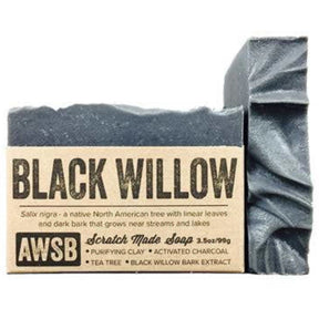 Black bar soap with a textured surface and a label that reads "Black Willow," "Scratch Made Soap," and "AWSB." The label also includes information about the ingredients and their benefits.