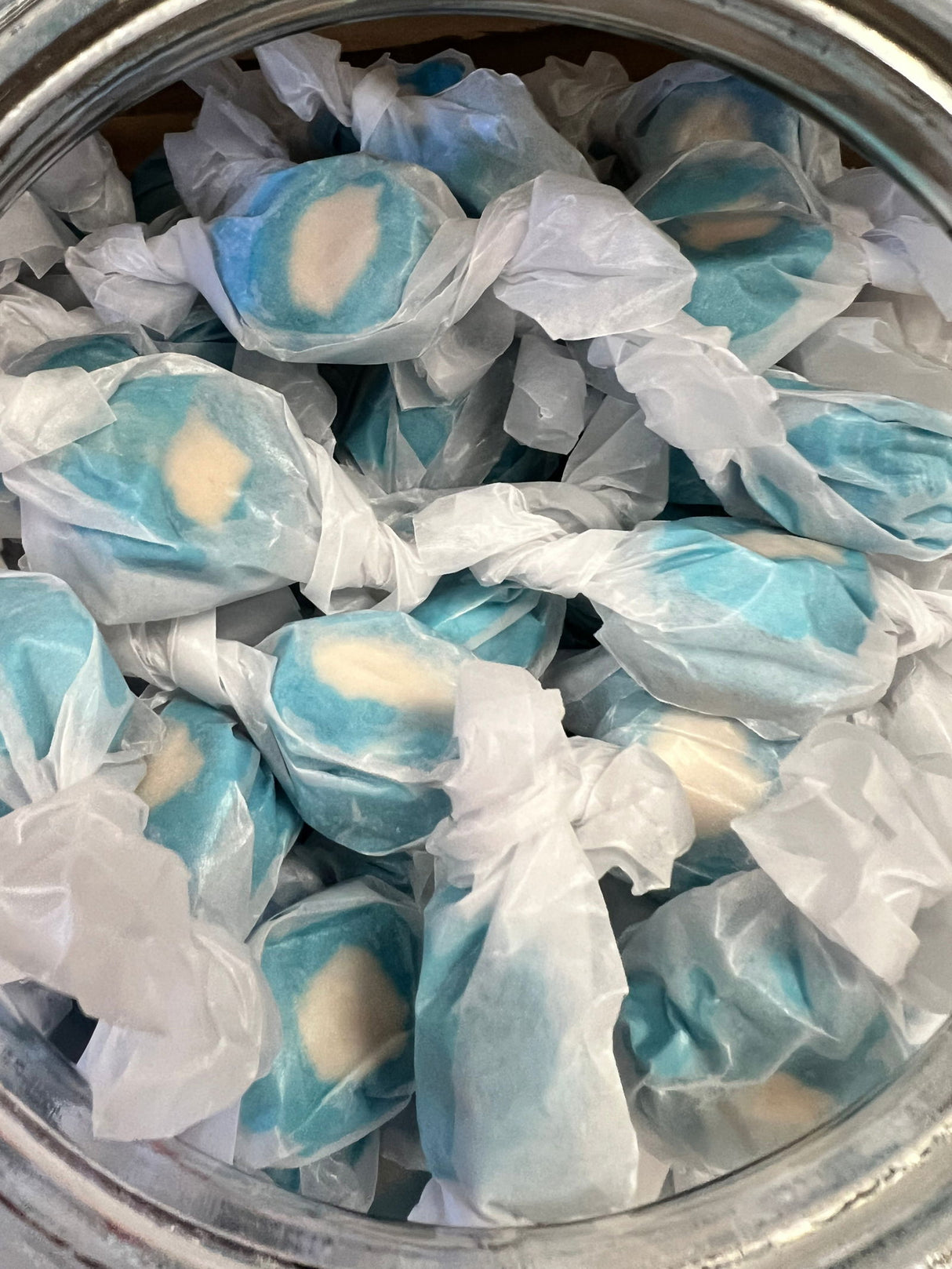 Blueberry Salt Water Taffy - blue candy pieces with a white filling wrapped in wax paper 