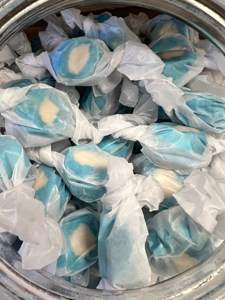 Blueberry Salt Water Taffy - blue candy pieces with a white filling wrapped in wax paper 