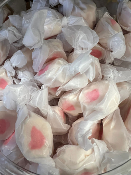 Cherry Salt Water Taffy - White candy pieces with red center wrapped in wax paper 
