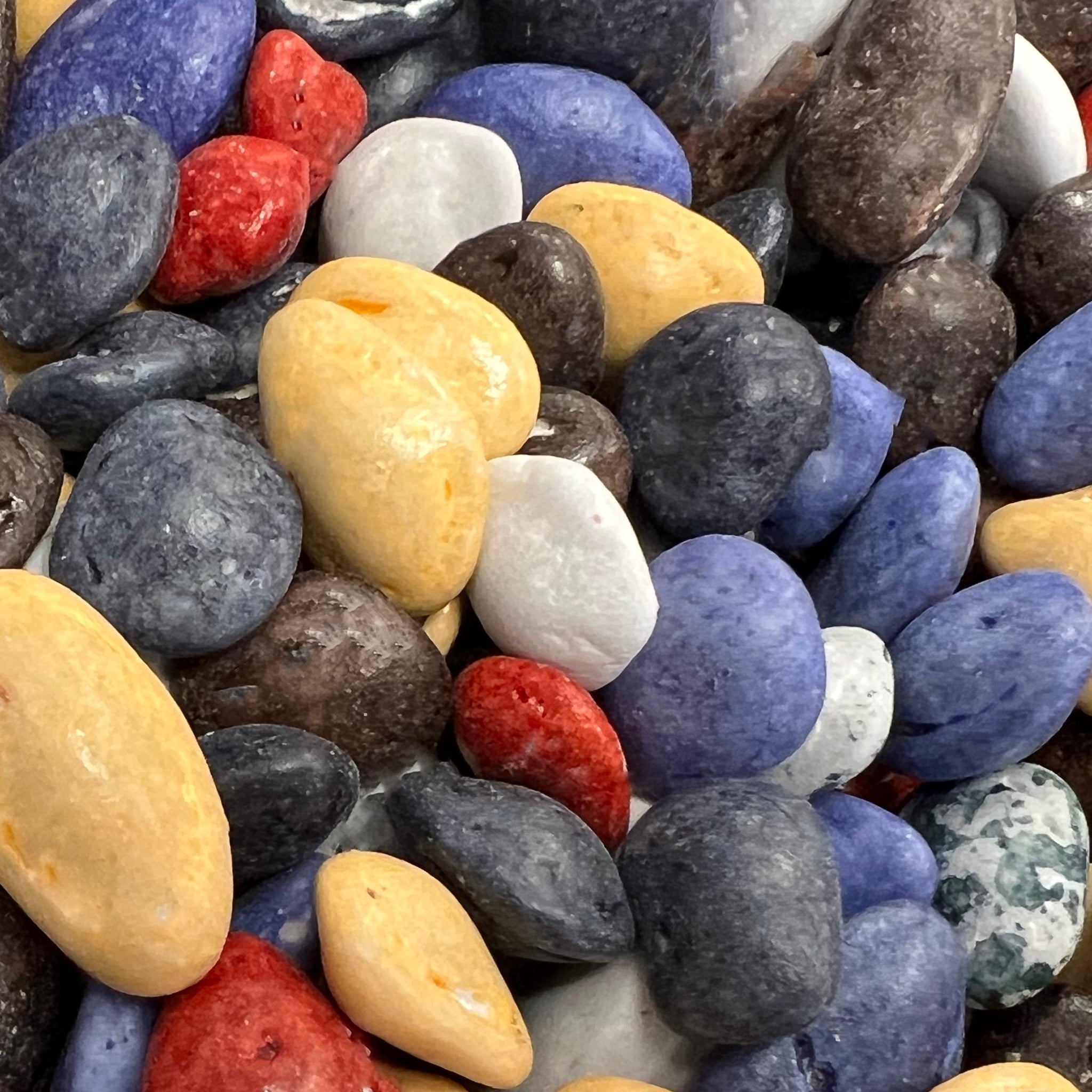 Different round shapes and colors of chocolate river rocks  rocks