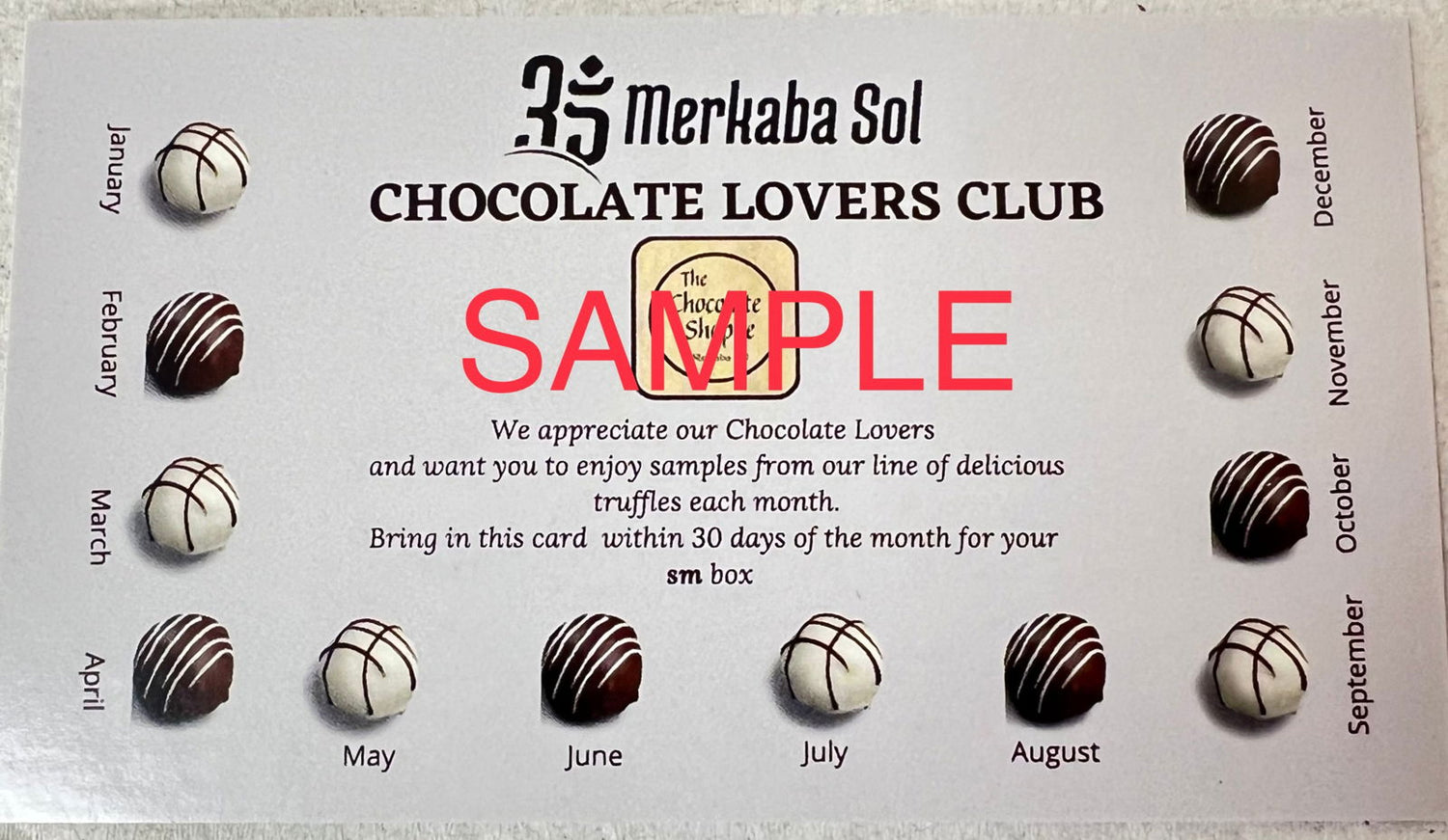 Chocolate Lovers Club Card Small - Chocolate Lovers Club Card Small.  This credit card shaped card is dark brown with pictures of white and dark chocolates bordering three edges.  Each picture of a chocolate has one of the months of the year below it.  