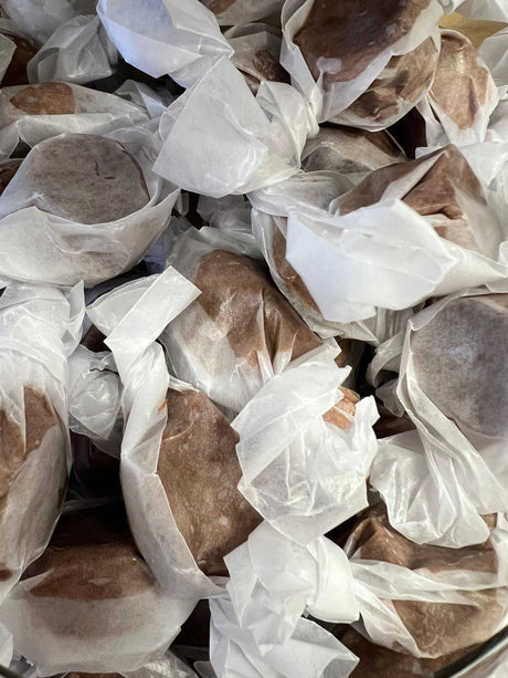 Chocolate Salt Water Taffy - Brown candy pieces wrapped in wax paper 