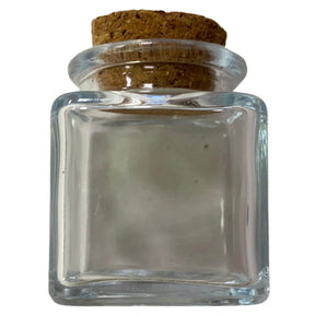 Small square glass jar with a cork stopper.