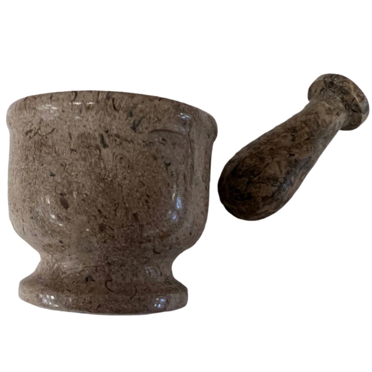 Small brown marble mortar and pestle set with fossilized coral inclusions.
