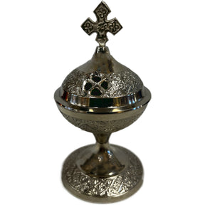 Small silver metal incense burner with a cross on top.